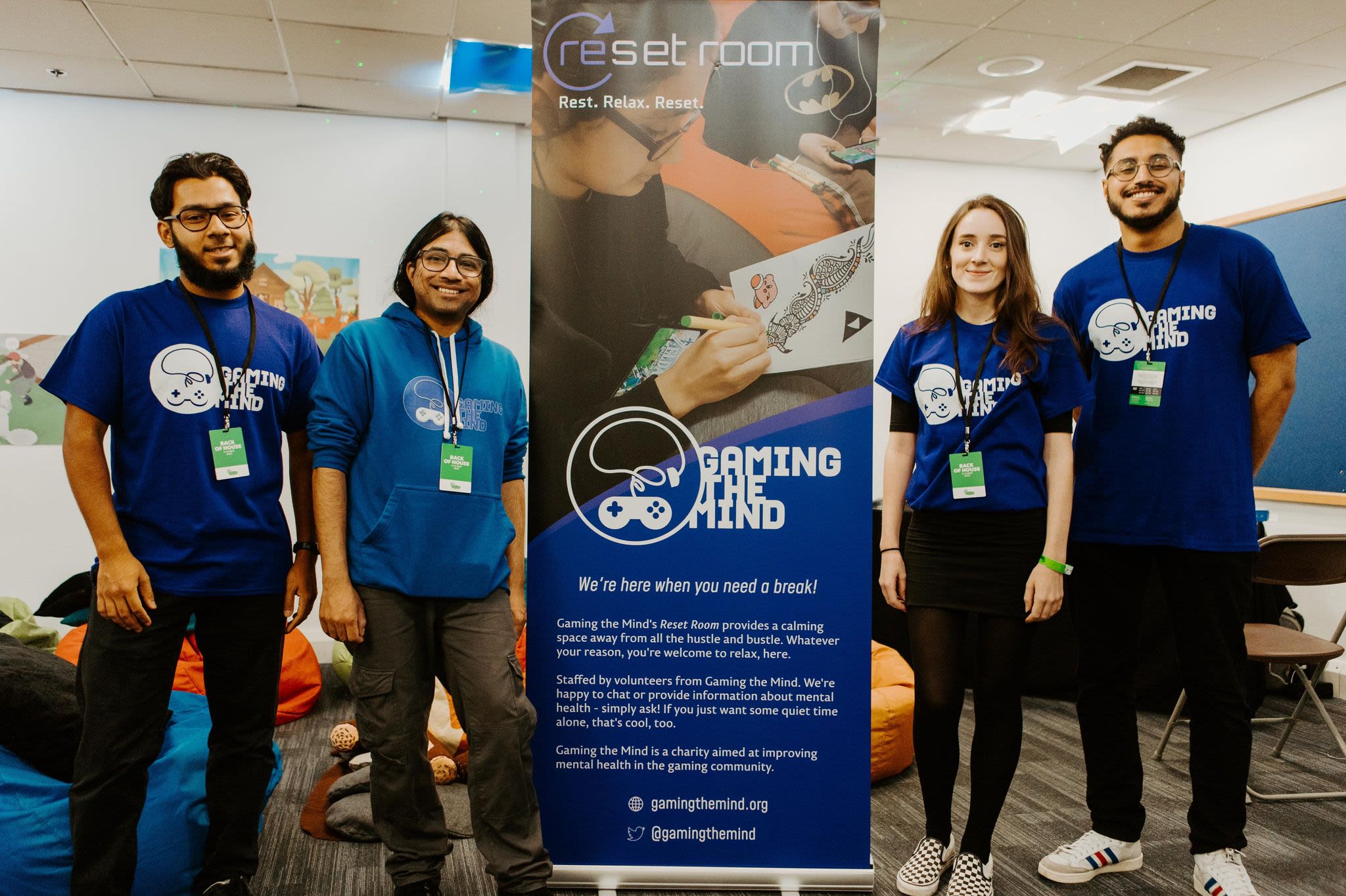 the 'gaming of the mind' team posed together in front of an information board