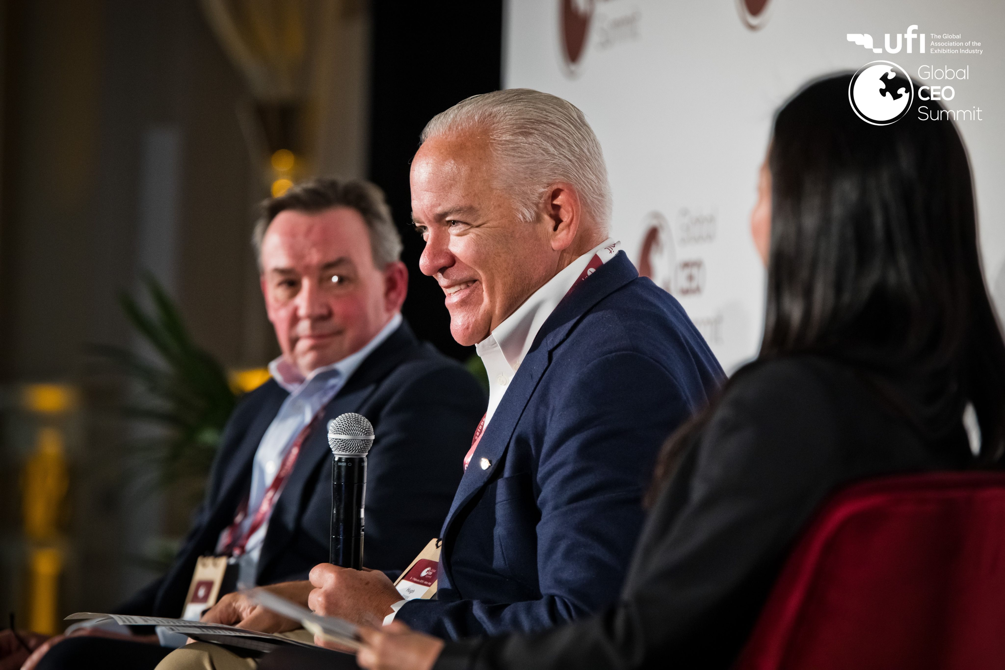 Speaker presenting on stage to an audience