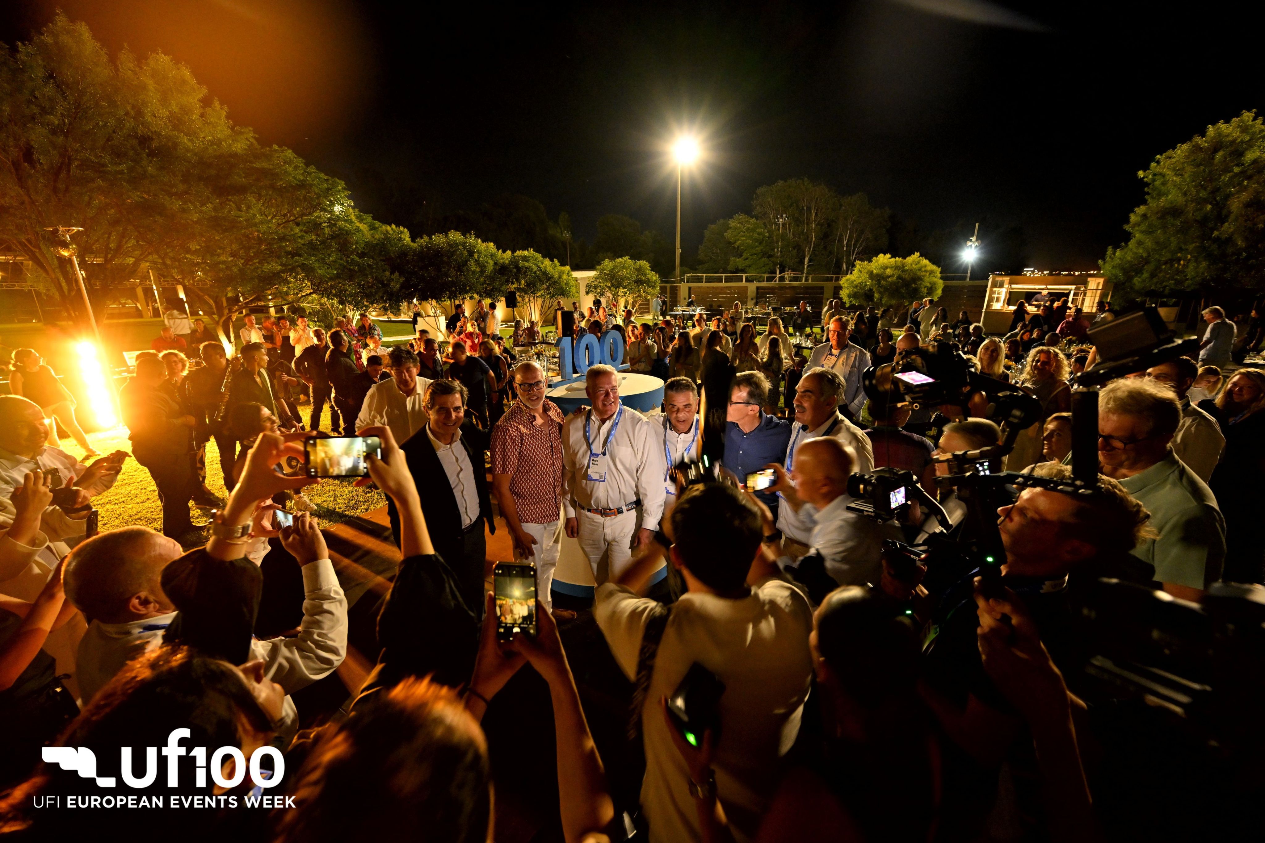 man performing DJ music with crowd during nighttime