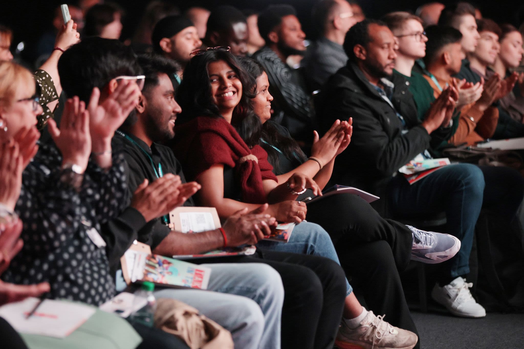 Diverse audience attentively listening at a conference event.